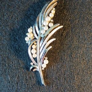 Silver and White Crescent Brooch with Nature-Inspired Design